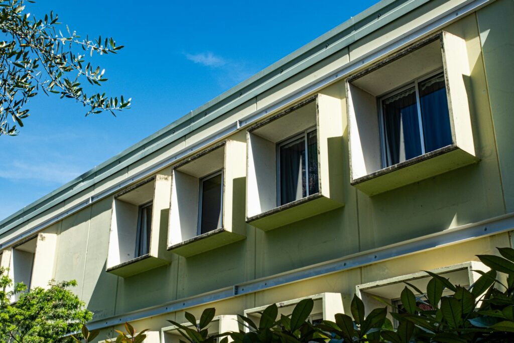 Modernist building with projecting window reveals designed as sunhoods to shade the rooms from the sun
